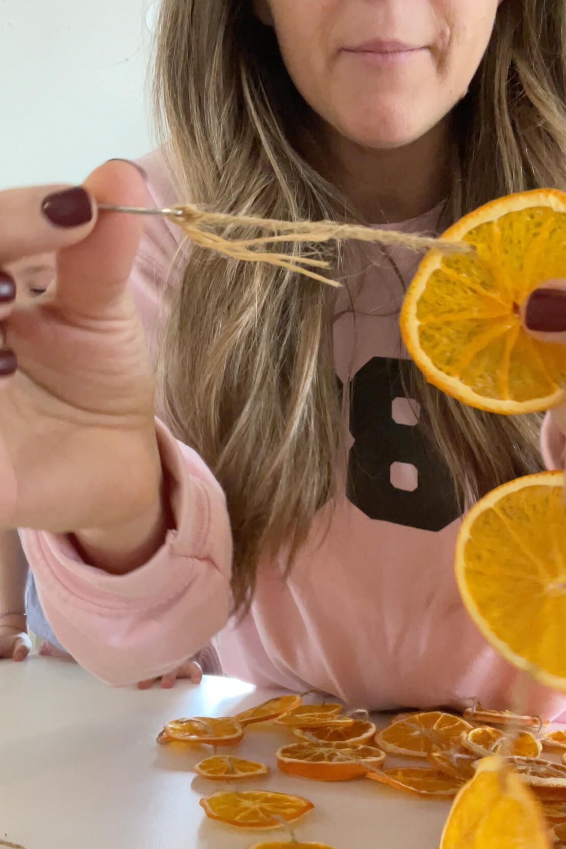 How to finish off a DIY orange slice garland.